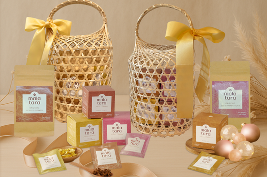 Mala Tara holiday tea gift baskets with assorted whole flower teas, sachets, and festive ornaments.