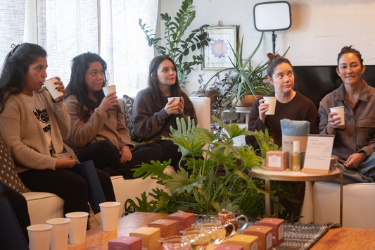Guests seated together at Mala Tara Sensory Event enjoying flower tea ritual session.